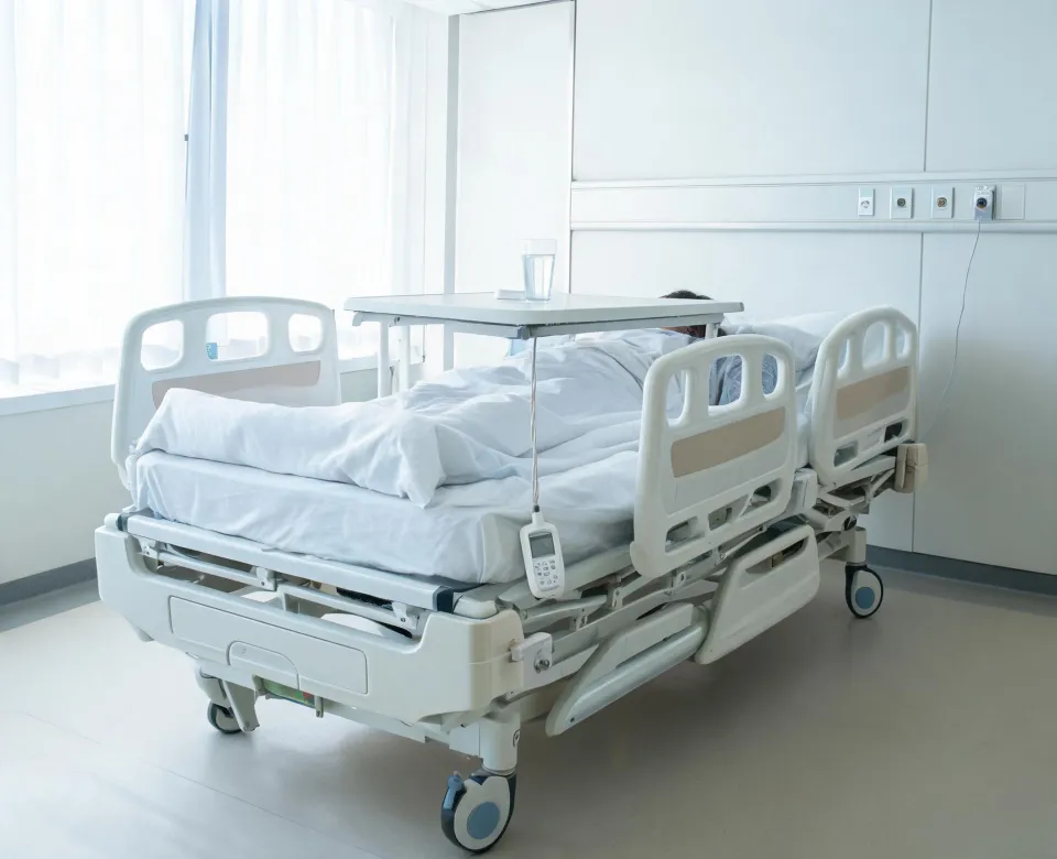 Hill Rom electric hospital bed in acute care room without patient face